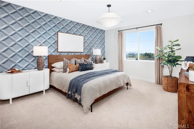 a bedroom with bed and a chandelier