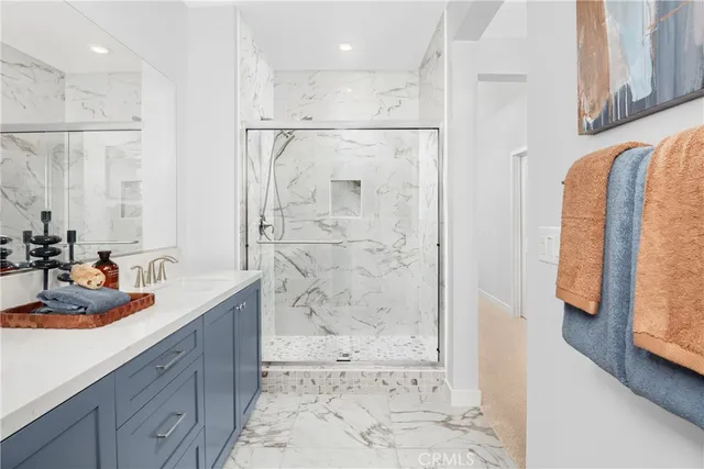 a bathroom with a granite countertop sink a shower and a mirror