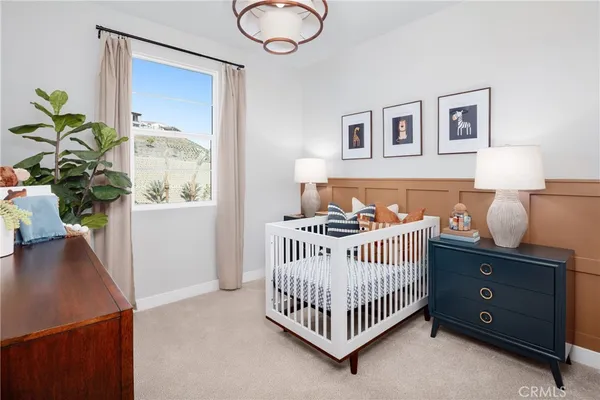 a bedroom with a bed and a potted plant
