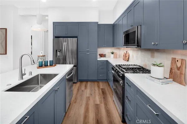 a kitchen with a sink stove and refrigerator