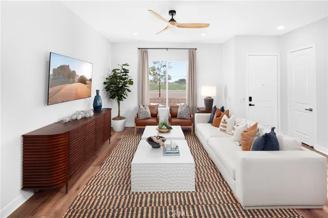 a living room with furniture fireplace and large window