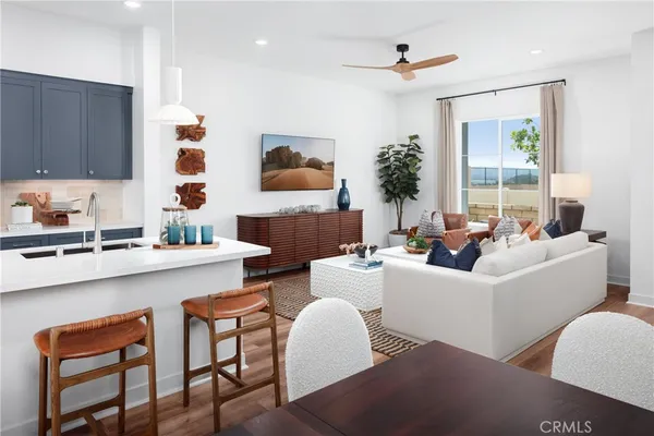 a living room with furniture a large window and a fireplace