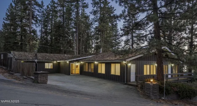 a view of an house with backyard and trees