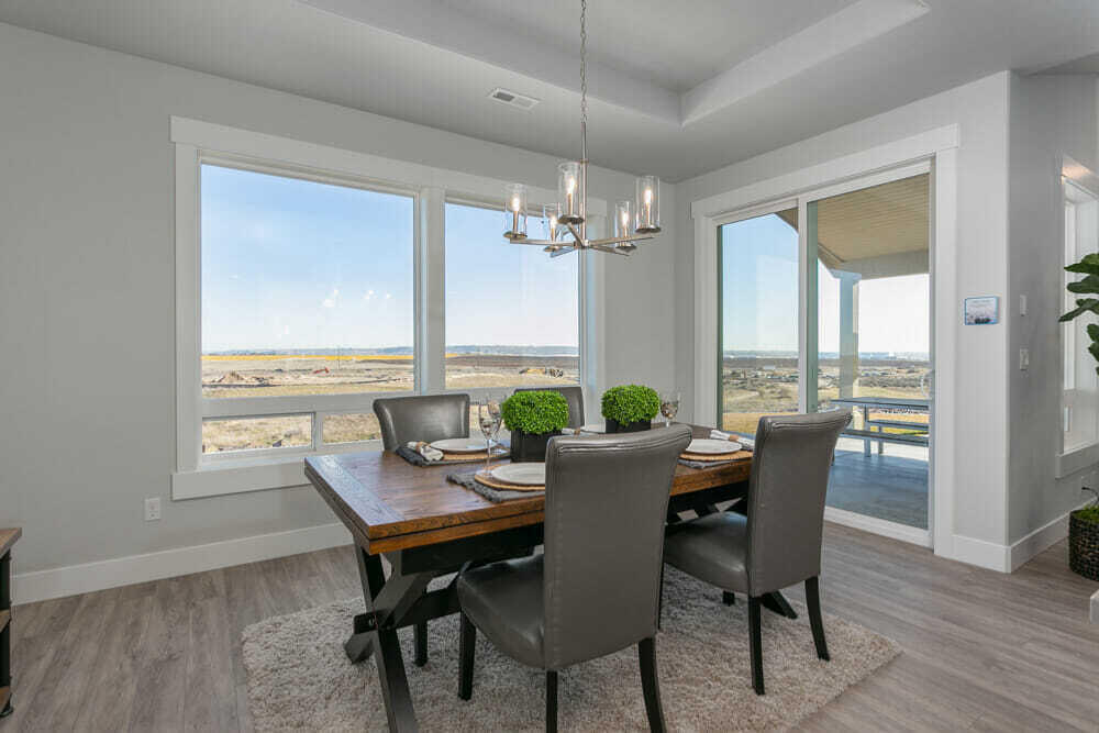 3803 Northeast Oakside Loop Bend, OR 97701 - Photo 7 of 22 a view of a dining room with furniture window and wooden floor