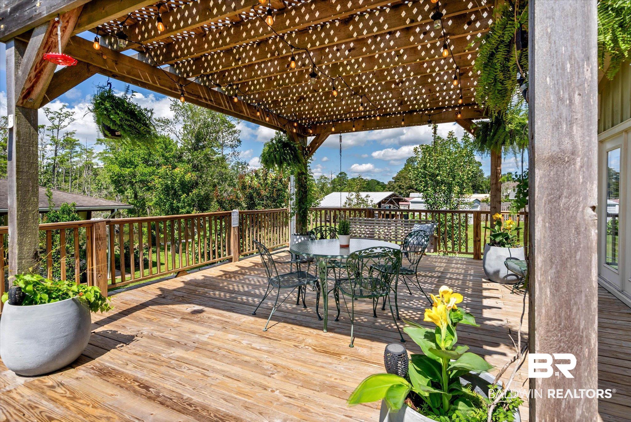 3801 Point Road Mobile, AL 36619 - Photo 33 of 55 Expansive wooden deck featuring a decorative pergola
