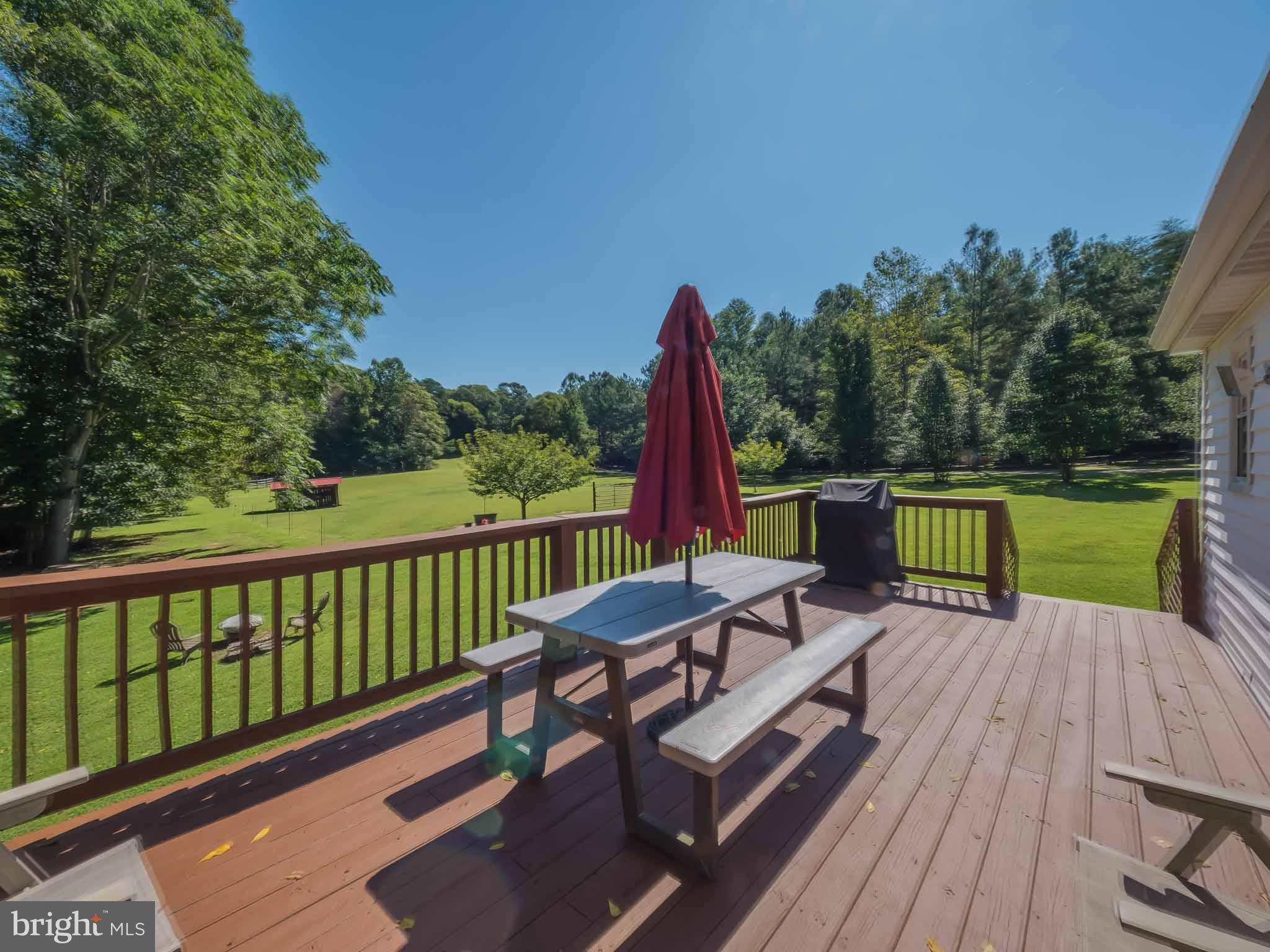 Looking from back deck to  fenced paddock area