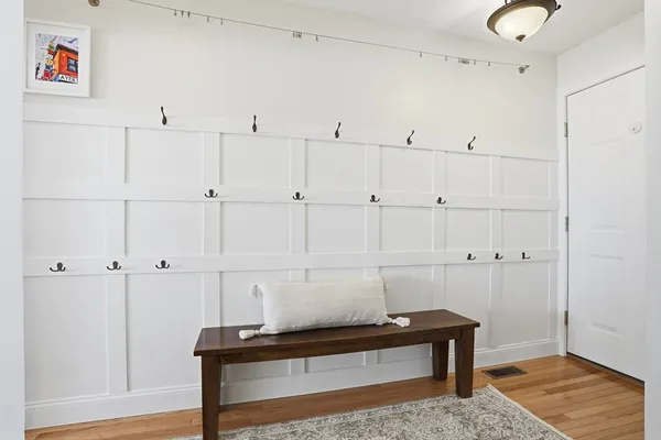 a view of a closet with wooden floor