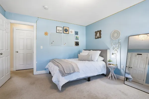 a spacious bedroom with a bed and a window
