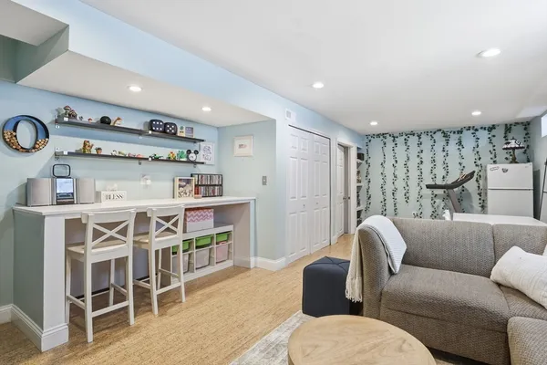 a living room with furniture a clock and a table