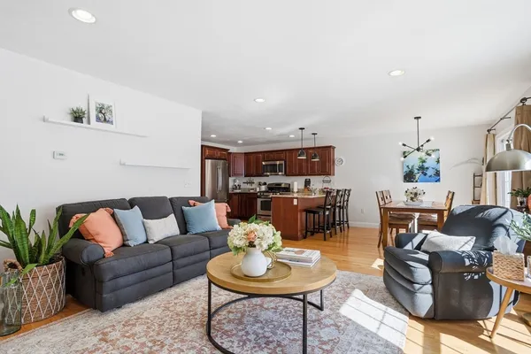 a living room with furniture and a dining table