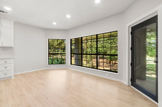 an empty room with windows and entryway