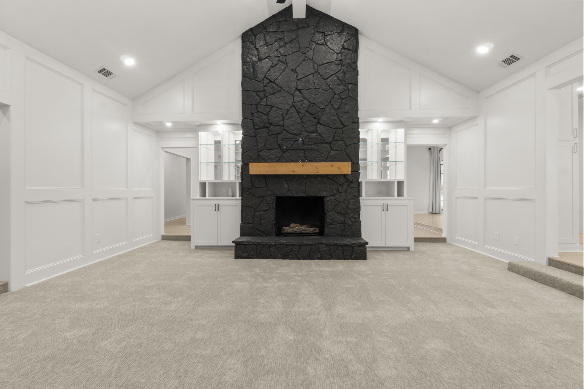 132 Mockingbird Lane Livingston, TX 77351 - Photo 16 of 50 an empty room with a fireplace cabinet and a rug