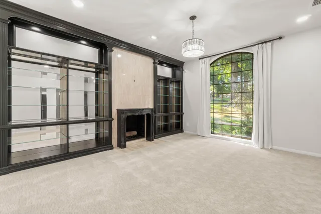 a bathroom with a granite countertop sink toilet and large mirror