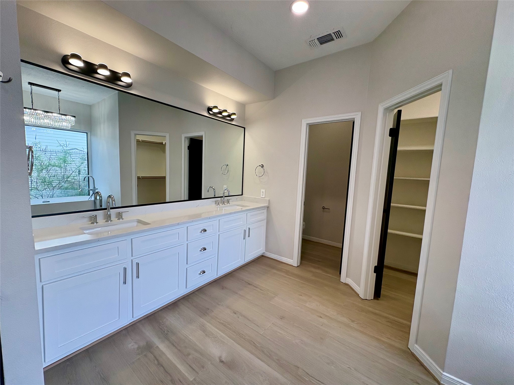 132 Mockingbird Lane Livingston, TX 77351 - Photo 25 of 50 a spacious bathroom with a double vanity sink and a mirror