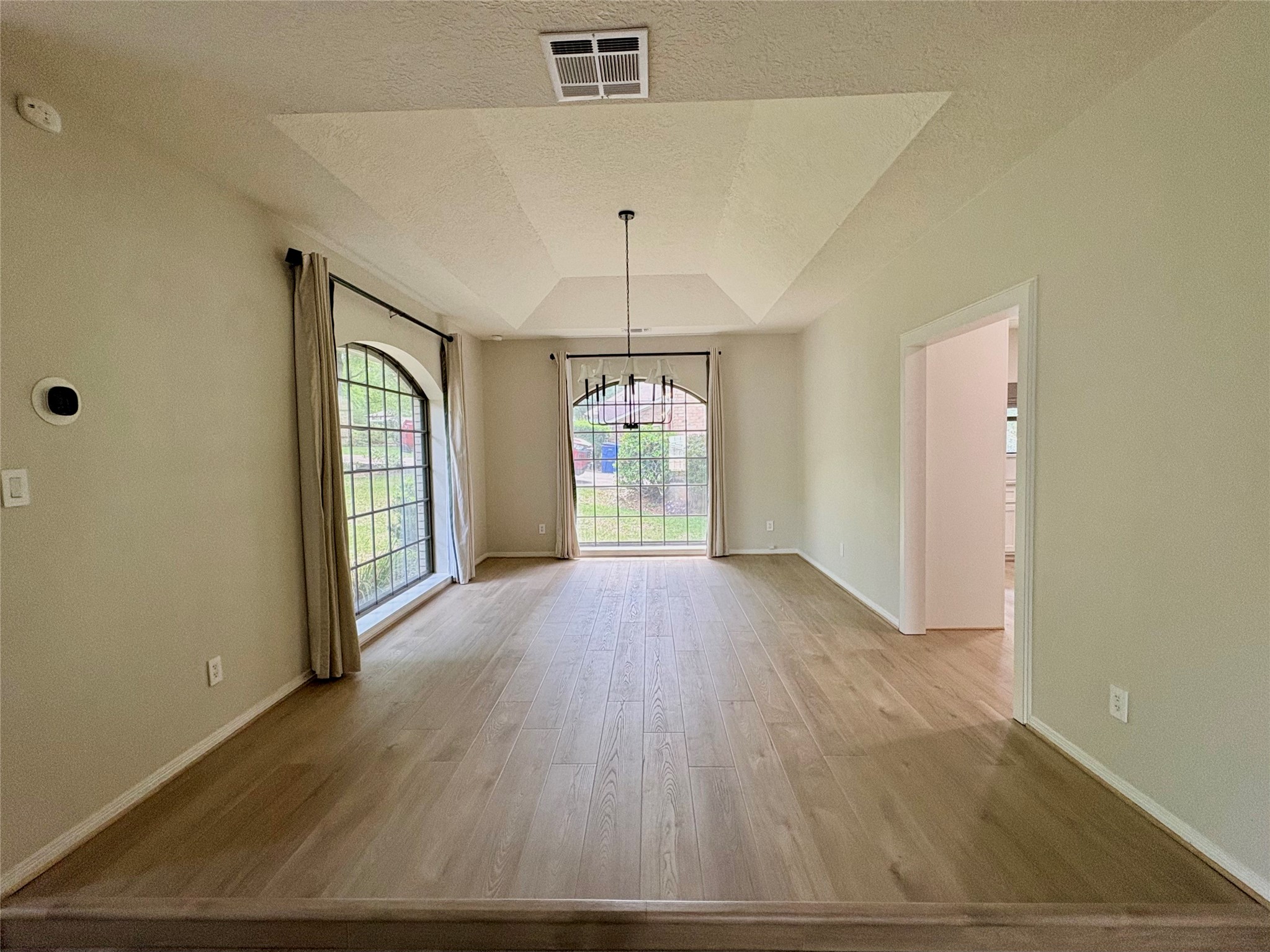 132 Mockingbird Lane Livingston, TX 77351 - Photo 7 of 50 an empty room with wooden floor and windows