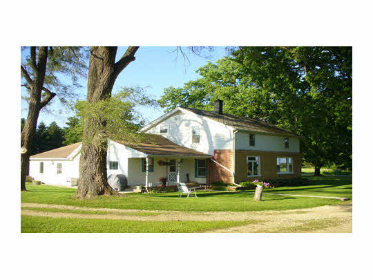 15236 Prairie Road South Beloit, IL 61080 - Photo 2 of 11 a front view of a house with a yard table and chairs