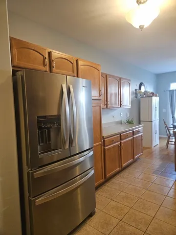 a kitchen with stainless steel appliances a refrigerator and a stove top oven