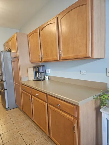 a kitchen with stainless steel appliances granite countertop a sink and a refrigerator