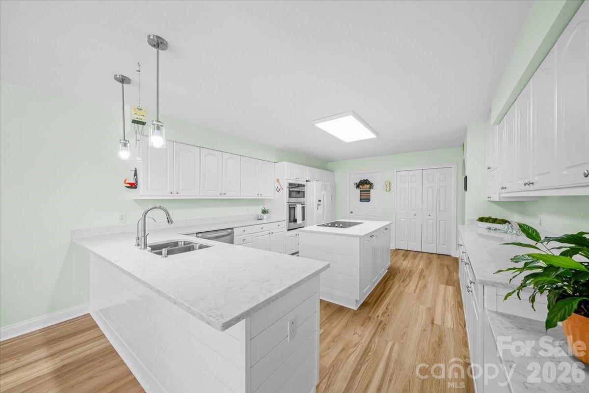 16601 Jefferson Place Fort Mill, SC 29708 - Photo 20 of 45 a view of a kitchen with a sink and dishwasher with wooden floor