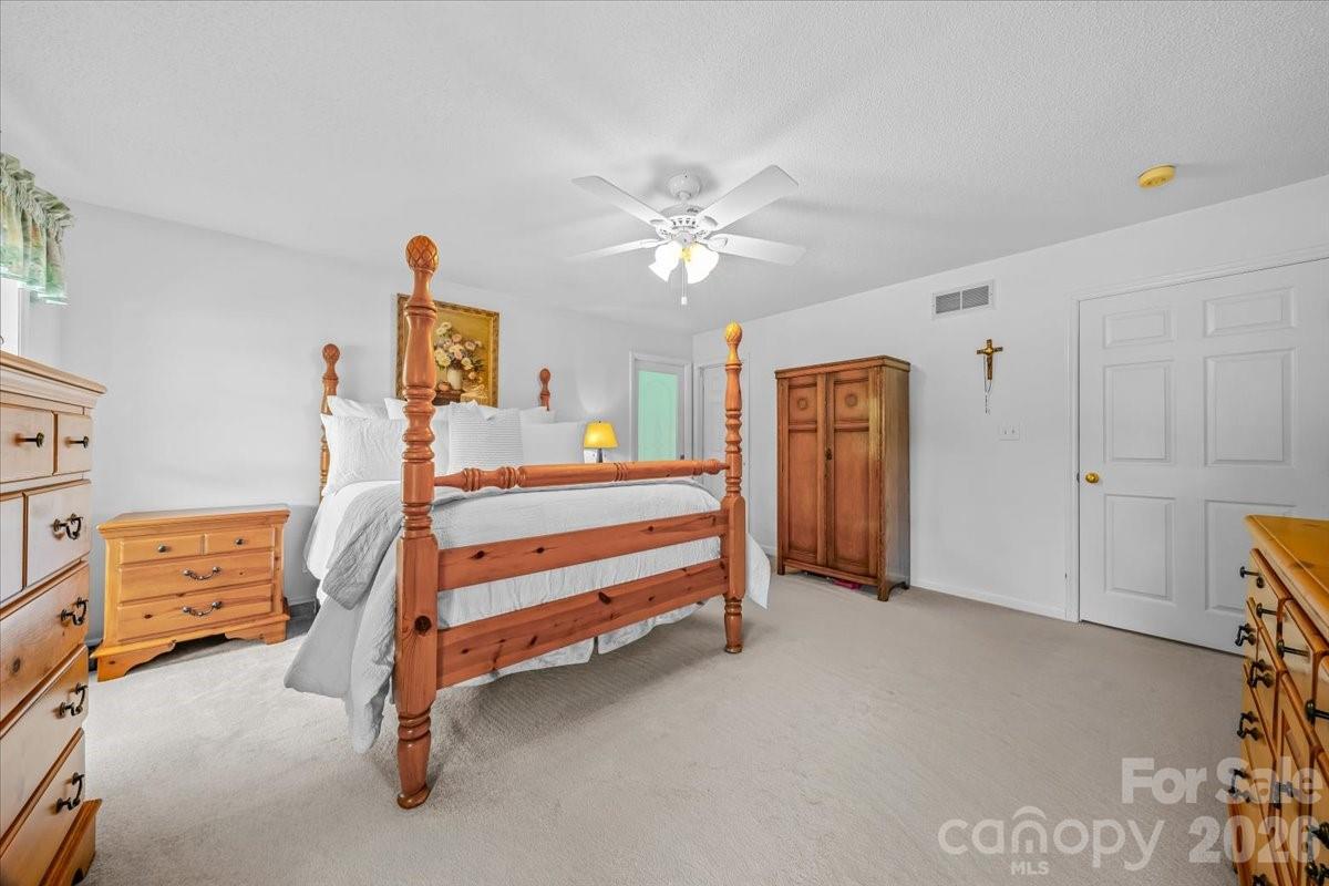 16601 Jefferson Place Fort Mill, SC 29708 - Photo 28 of 45 a bedroom with furniture and a chandelier