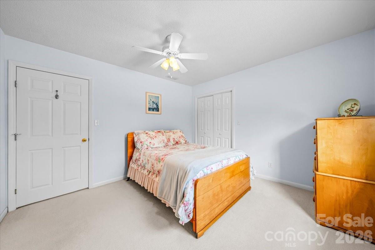 16601 Jefferson Place Fort Mill, SC 29708 - Photo 33 of 45 a bedroom with a bed and a chandelier