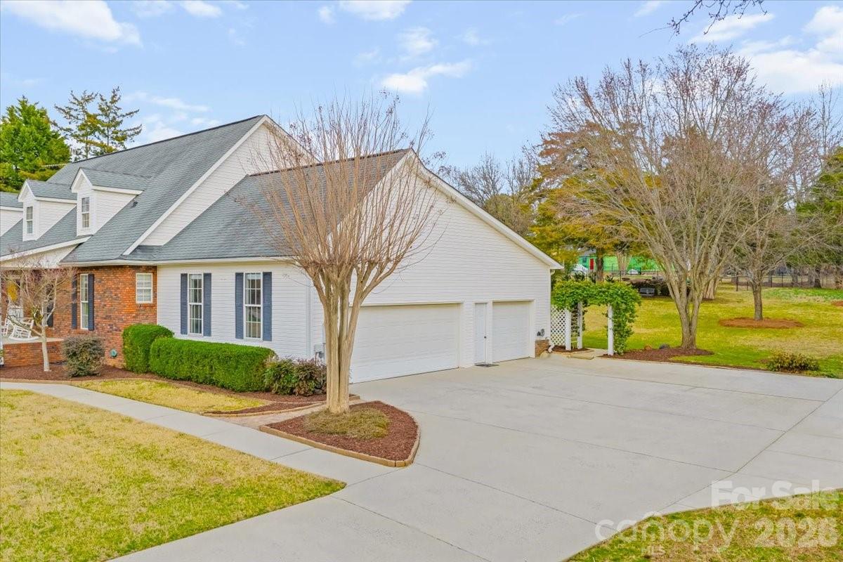 16601 Jefferson Place Fort Mill, SC 29708 - Photo 7 of 45 a view of a house next to a yard with large trees