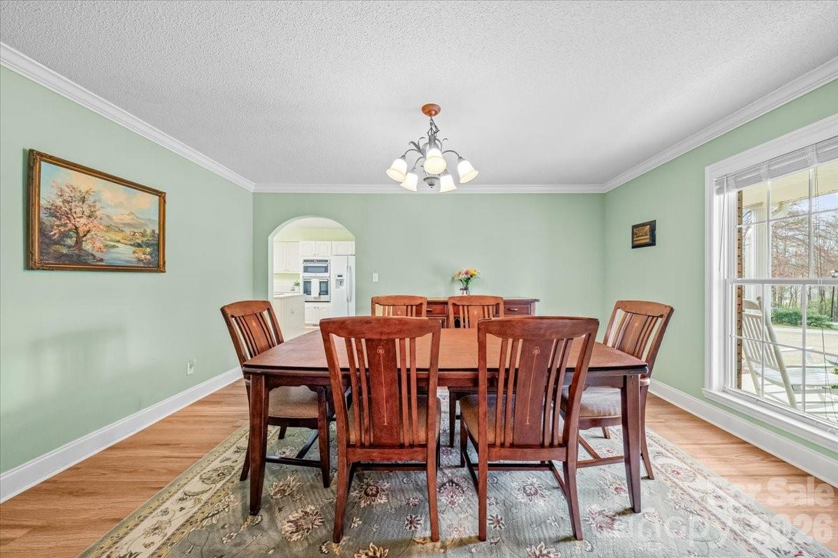 16601 Jefferson Place Fort Mill, SC 29708 - Photo 9 of 45 a view of a dining room with furniture window and wooden floor