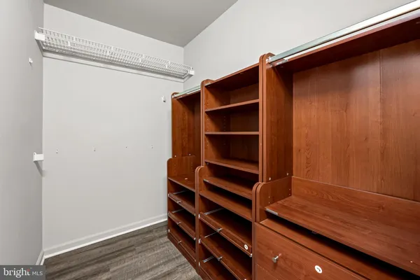 a view of walk in closet with empty racks