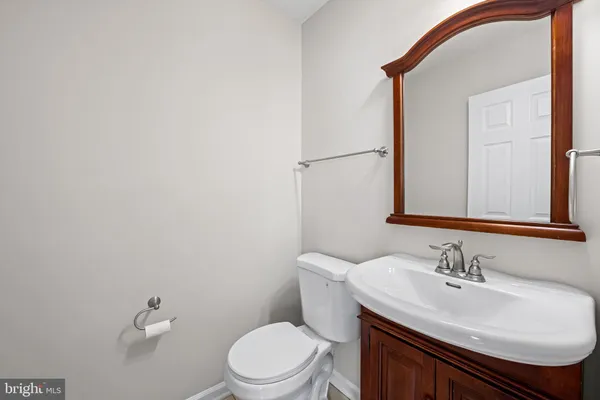 a bathroom with a sink a toilet and mirror