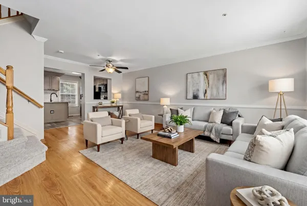 a living room with furniture and view of kitchen
