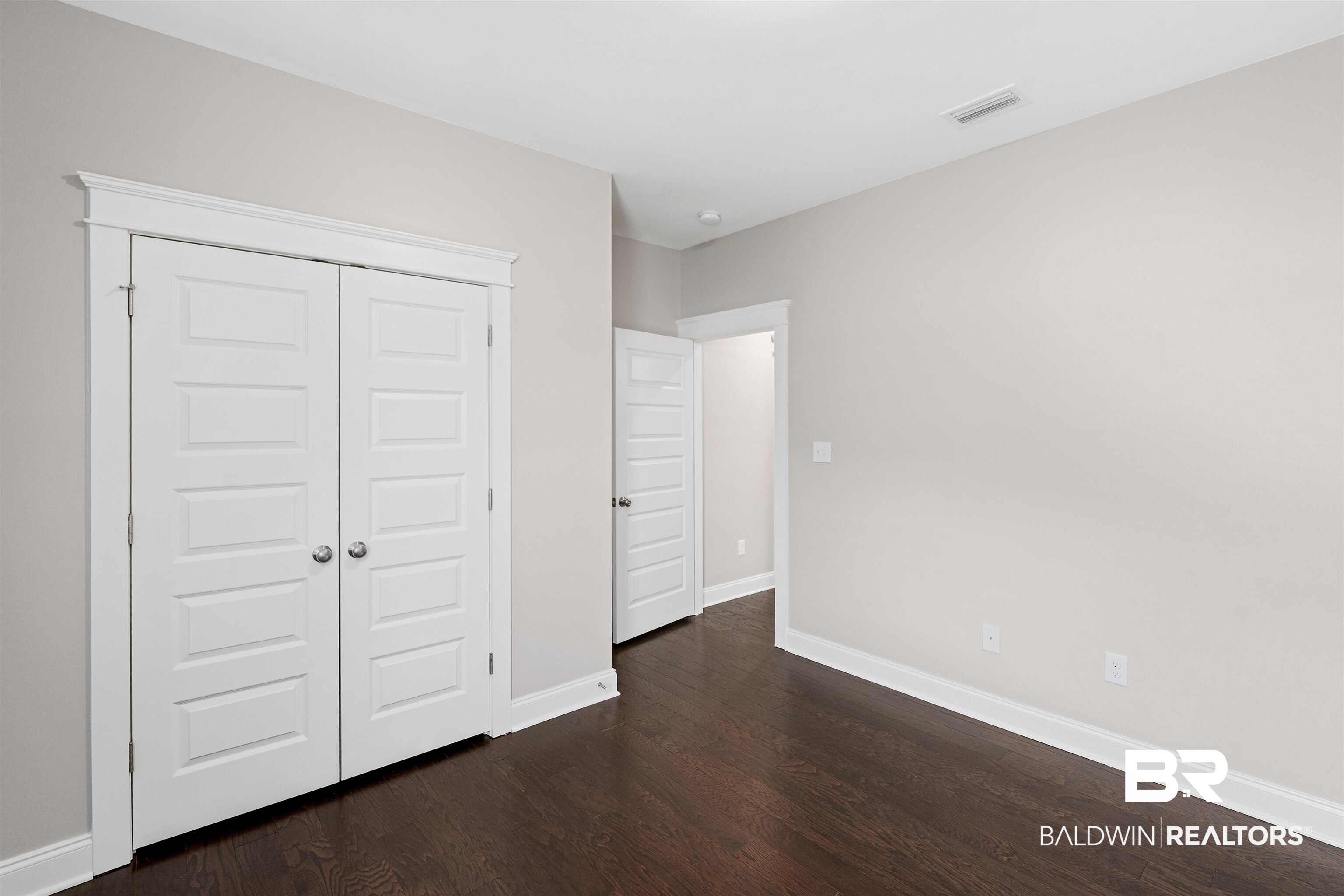 24838 Slater Mill Road Daphne, AL 36526 - Photo 29 of 46 Unfurnished bedroom with a closet and dark wood-type flooring