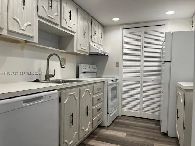 a kitchen with stainless steel appliances a sink and cabinets