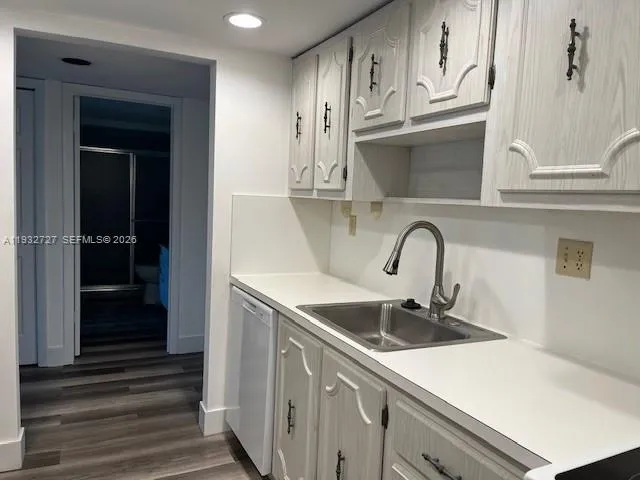 a kitchen with stainless steel appliances granite countertop a sink and cabinets
