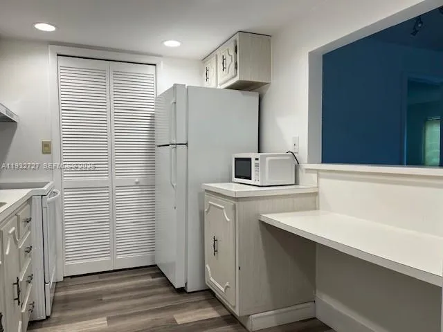 a kitchen with a sink and refrigerator