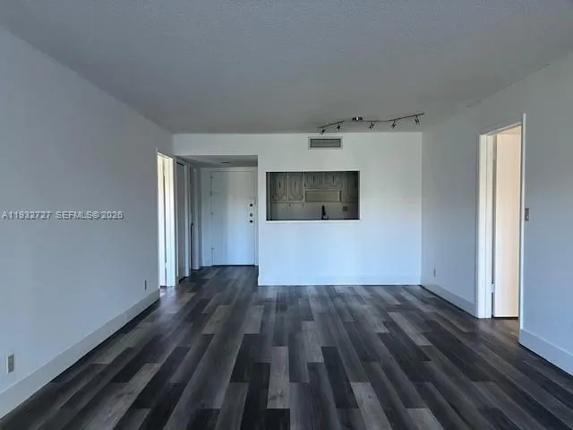 a view of a room with wooden floor