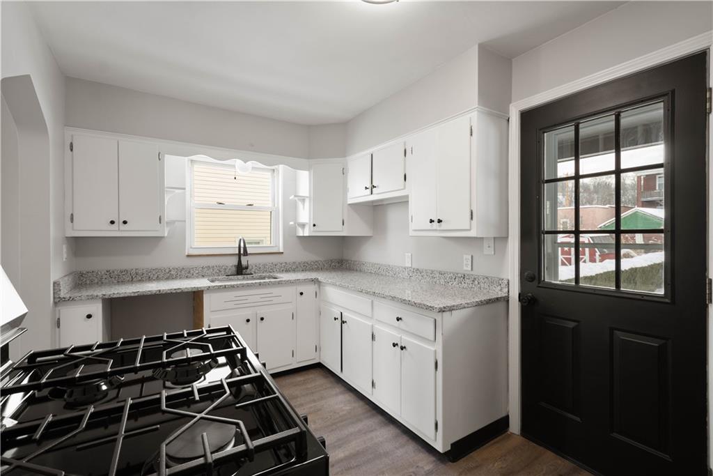 1613 Clarkton Street Pittsburgh, PA 15204 - Photo 11 of 23 a kitchen that has a sink and a stove