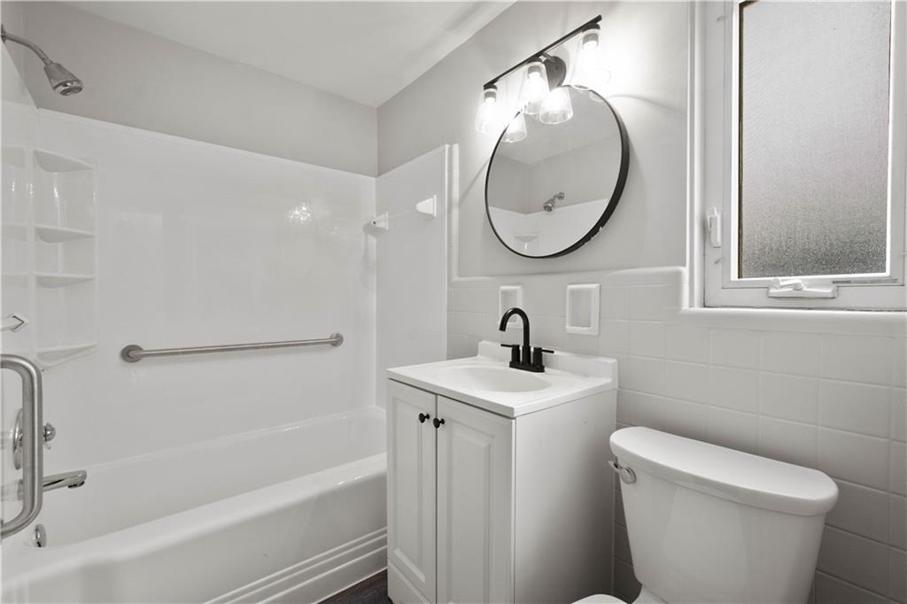 1613 Clarkton Street Pittsburgh, PA 15204 - Photo 14 of 23 a bathroom with a toilet sink and mirror
