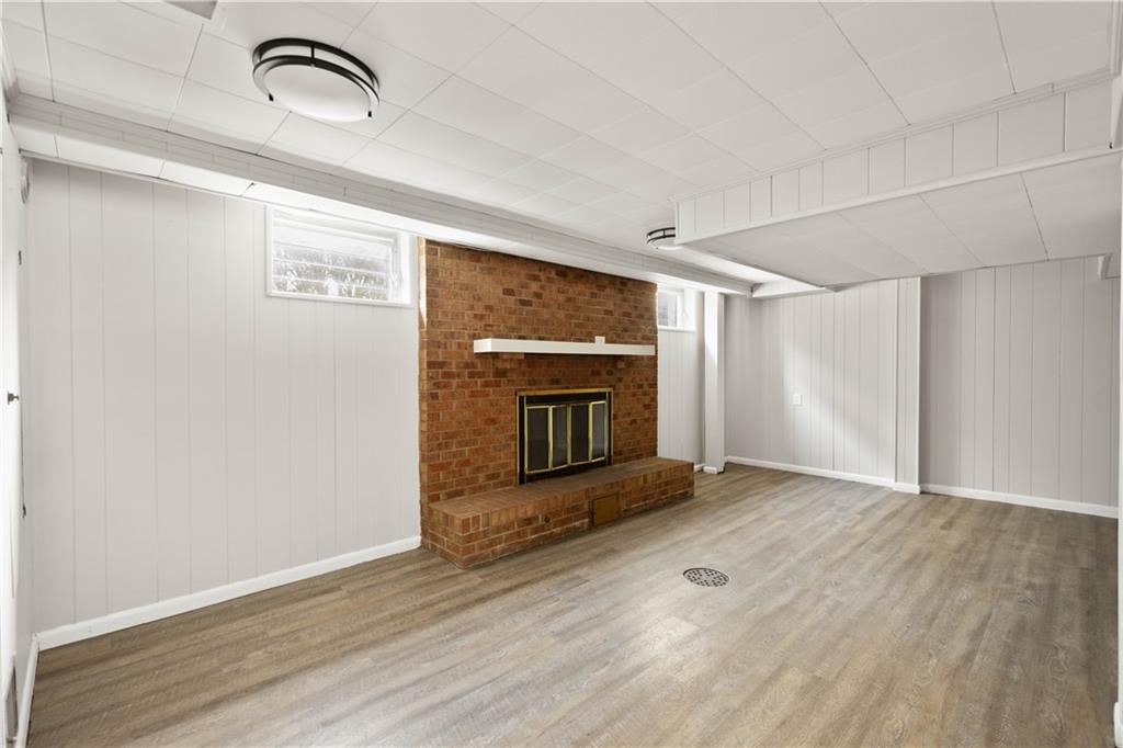 1613 Clarkton Street Pittsburgh, PA 15204 - Photo 17 of 23 a view of empty room with wooden floor and fireplace