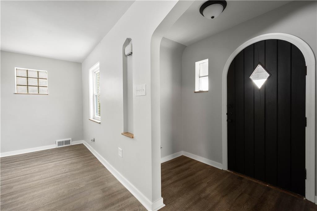 1613 Clarkton Street Pittsburgh, PA 15204 - Photo 5 of 23 an empty room with wooden floor and windows