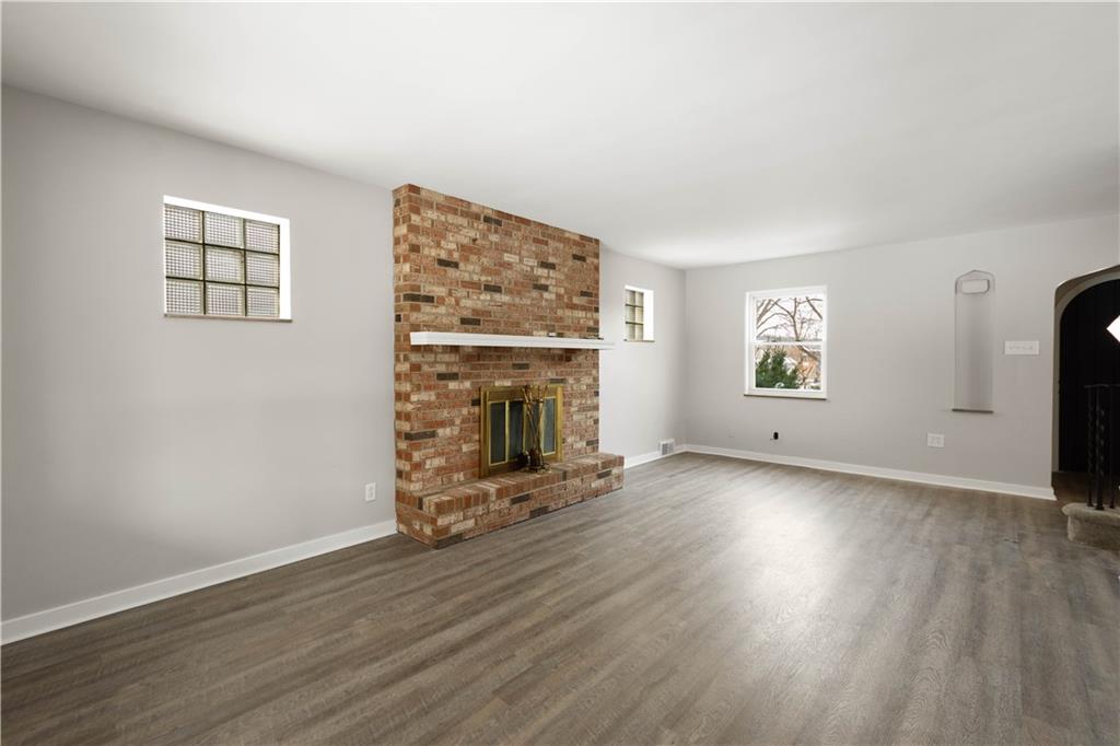 1613 Clarkton Street Pittsburgh, PA 15204 - Photo 6 of 23 an empty room with windows and fireplace