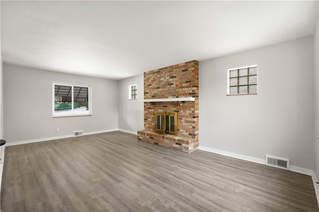 1613 Clarkton Street Pittsburgh, PA 15204 - Photo 7 of 23 an empty room with wooden floor and windows