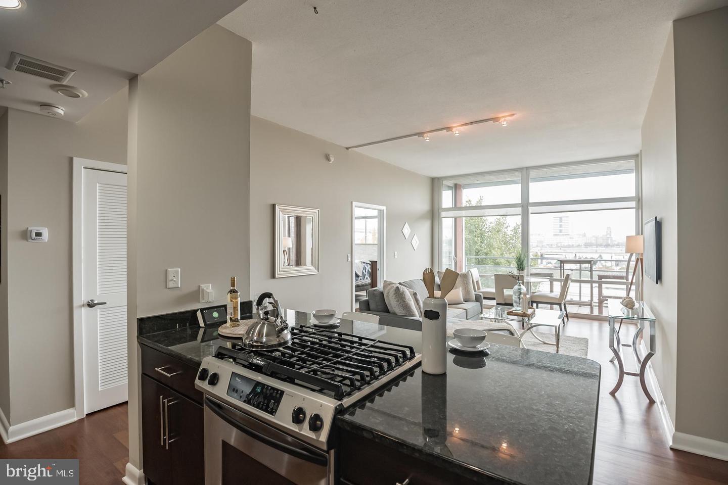 22 South Front Street, Unit 207 Philadelphia, PA 19106 - Photo 11 of 32 a kitchen with sink stove and glass door