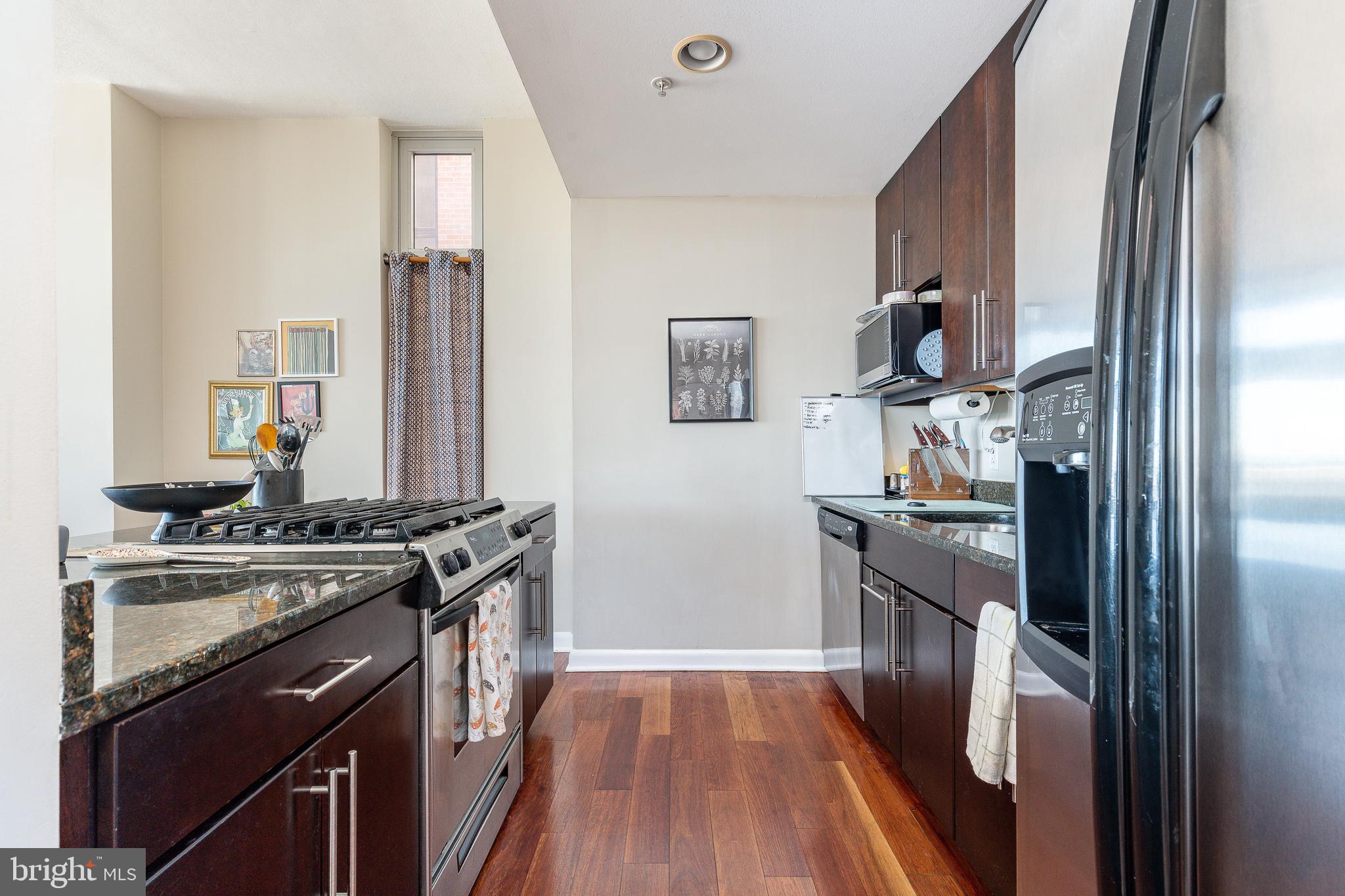 22 South Front Street, Unit 207 Philadelphia, PA 19106 - Photo 13 of 32 a kitchen with a sink stove and refrigerator