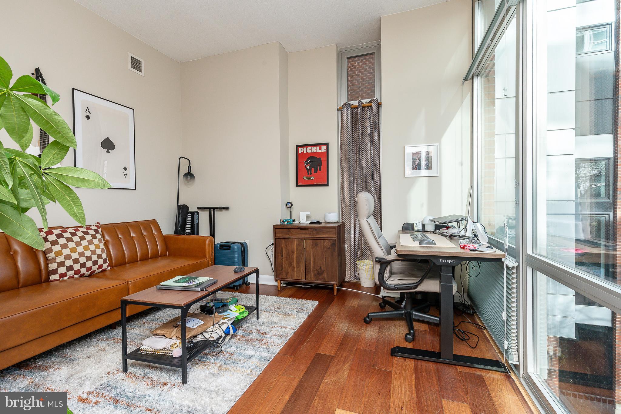 22 South Front Street, Unit 207 Philadelphia, PA 19106 - Photo 14 of 32 a living room with furniture a rug and a floor to ceiling window