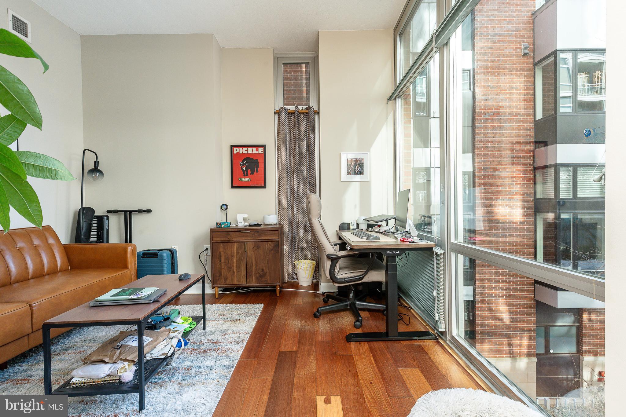 22 South Front Street, Unit 207 Philadelphia, PA 19106 - Photo 15 of 32 a living room with furniture a rug and a floor to ceiling window