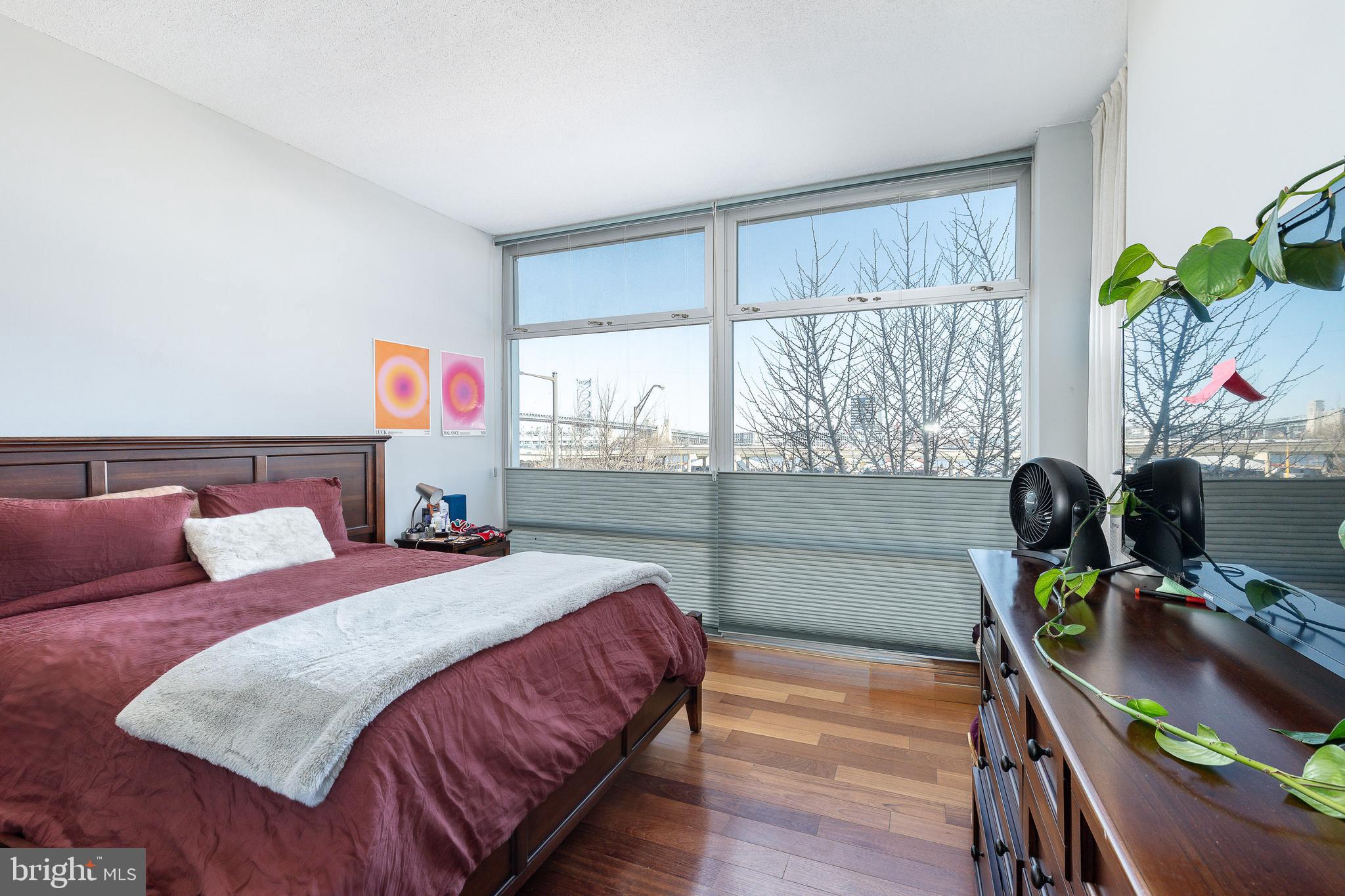 22 South Front Street, Unit 207 Philadelphia, PA 19106 - Photo 17 of 32 a bedroom with a bed furniture and a window
