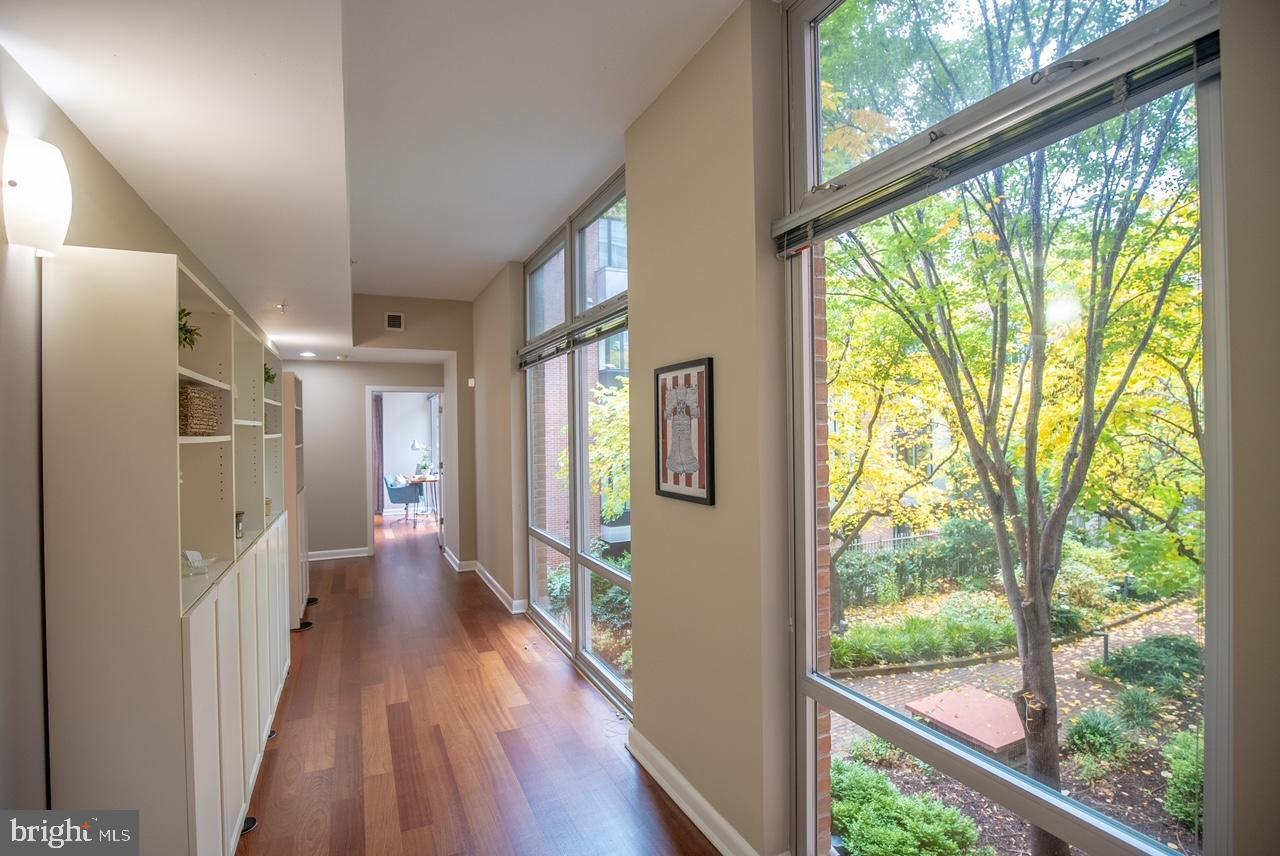 22 South Front Street, Unit 207 Philadelphia, PA 19106 - Photo 2 of 32 a view of hallway with a large window and wooden floor