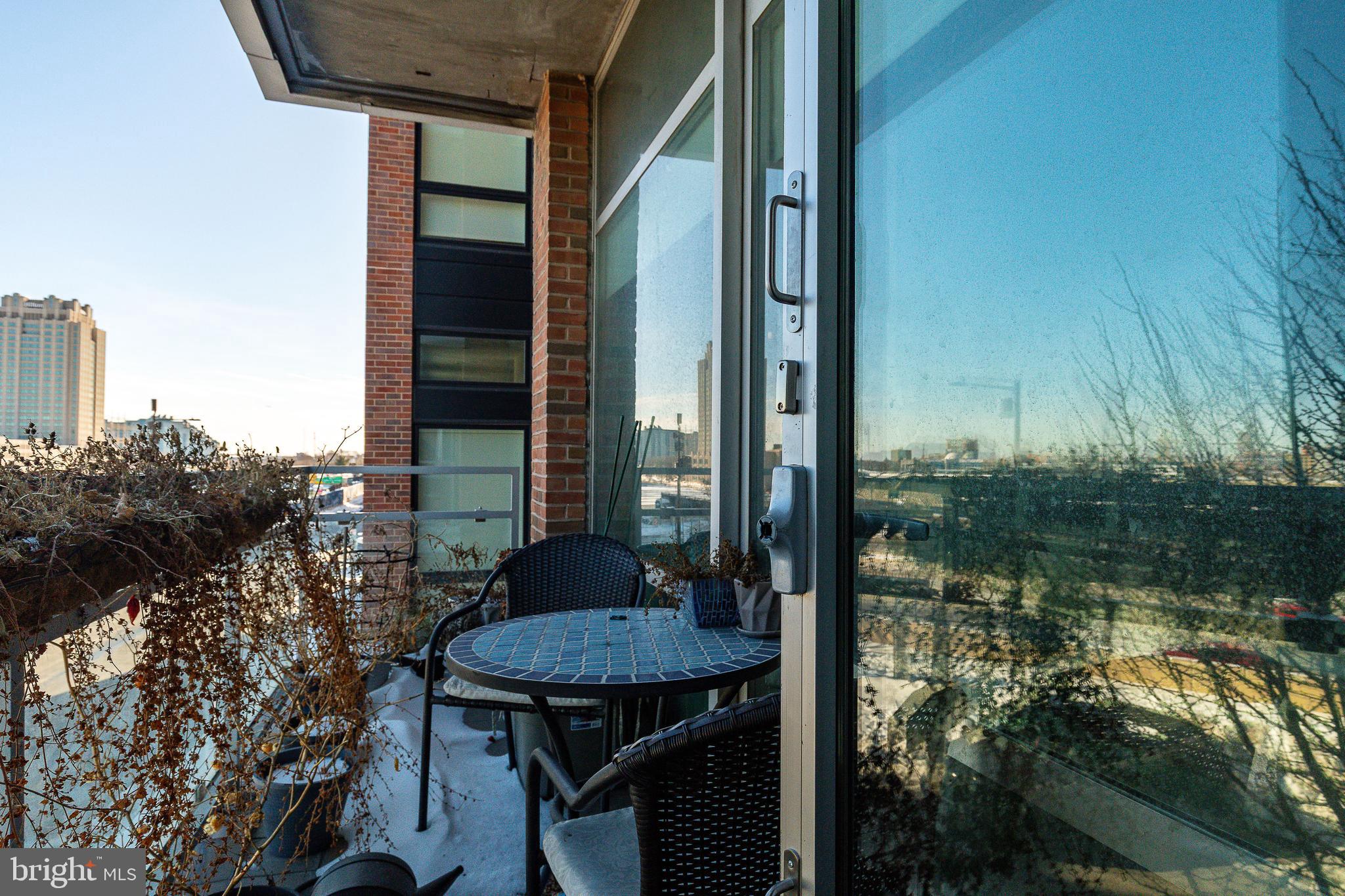 22 South Front Street, Unit 207 Philadelphia, PA 19106 - Photo 22 of 32 a balcony with table and chairs