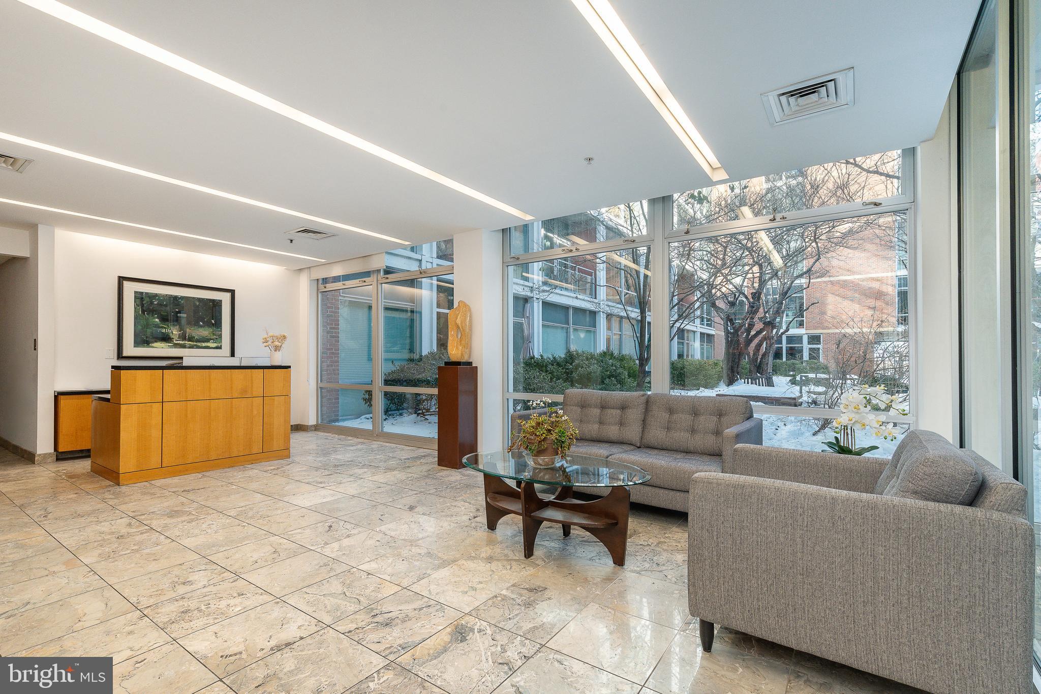22 South Front Street, Unit 207 Philadelphia, PA 19106 - Photo 23 of 32 a living room with furniture and a floor to ceiling window