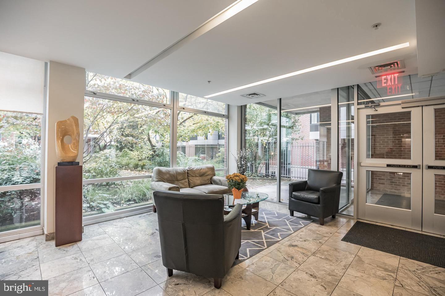22 South Front Street, Unit 207 Philadelphia, PA 19106 - Photo 30 of 32 a living room with furniture and a floor to ceiling window